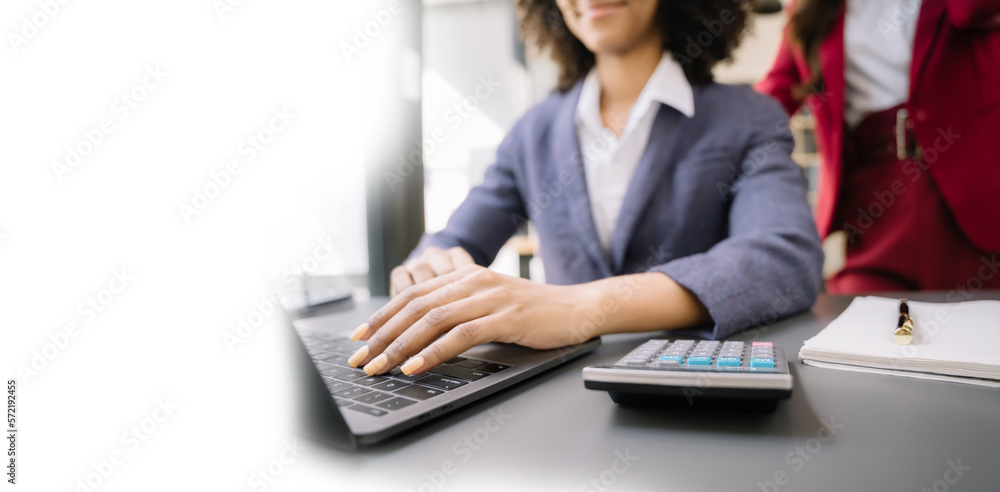 Business woman working on laptop and accounting financial report, accountant using calculator to calculate tax refund at office with copy space.