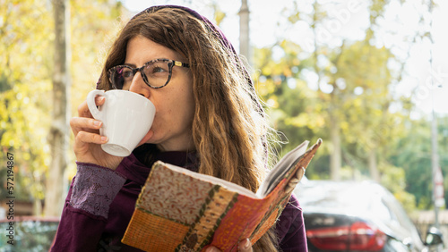 Wallpaper Mural Girl with glasses drinking coffee in a white mug looking away from camera wearing a purple hoodie Torontodigital.ca