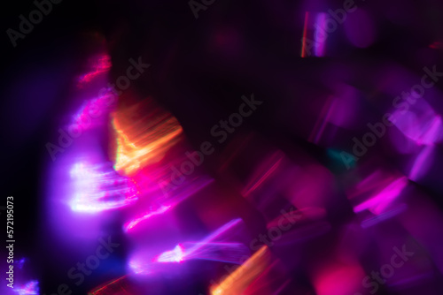 Abstract blurred colorful lens flare bokeh on black 