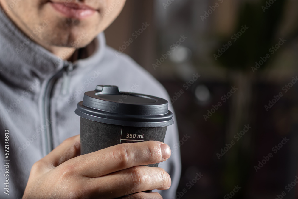 Man drinking coffee from disposable cup close up Man drinking coffee from disposable cup close up