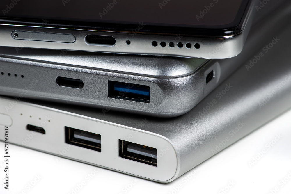 Powerbank for charging mobile devices on white. Smartphone with power bank. External battery for mobile devices Powerbank for charging mobile devices on white. Smartphone with power bank. External battery for mobile devices