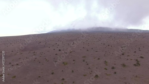 Aerial view of the volcanic plains in Cotopaxi with a Volcano hidden in mist
