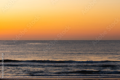 Empty ocean with clear sky at dawn.
