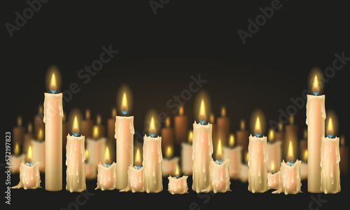 A glowing candles with melted wax. Composition of burning candles on dark background.