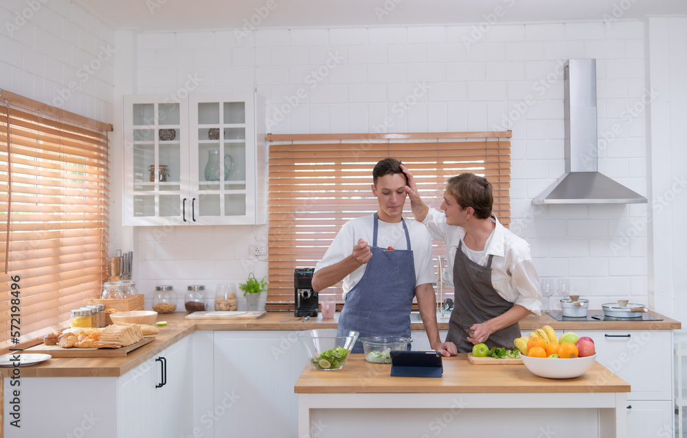 A young couple enters the kitchen to prepare dinner for celebrating the anniversary of being together for many years