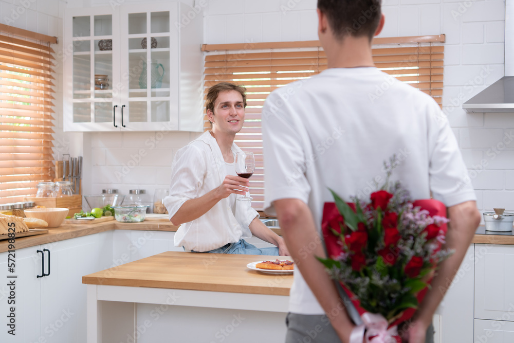 A young LGBT couple celebrates the day of love with a glass of wine in their home kitchen. with a surprise with a rose from a lover A young LGBT couple celebrates the day of love with a glass of wine in their home kitchen. with a surprise with a rose from a lover