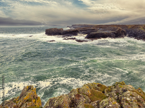 Stunning Irish seascape with rough stone coast line and powerful Atlantic ocean. Kilkee area, Ireland. Dramatic sky. Detailed nature scene. Popular travel and sightseeing area