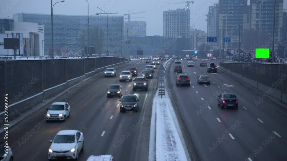 4k Urban transport view and mockup screen in city in winter spbas. Traffic is driving on highway in town with buildings, signs and lightbox for advertising in cold snowy weather. Beautiful pic of 4k Urban transport view and mockup screen in city in winter spbas. Traffic is driving on highway in town with buildings, signs and lightbox for advertising in cold snowy weather. Beautiful pic of