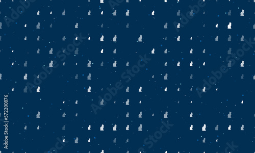 Seamless background pattern of evenly spaced white cat symbols of different sizes and opacity. Vector illustration on dark blue background with stars