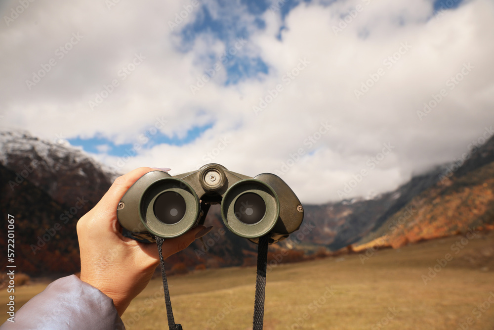 Boy holding binoculars in beautiful mountains, closeup. Space for text Boy holding binoculars in beautiful mountains, closeup. Space for text