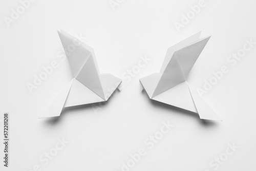 Beautiful origami birds on white background, flat lay