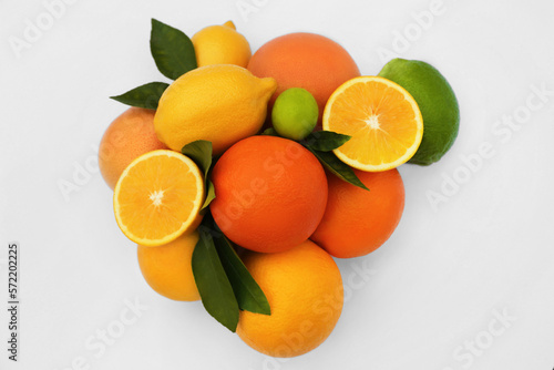 Different citrus fruits and leaves on white background, top view © New Africa