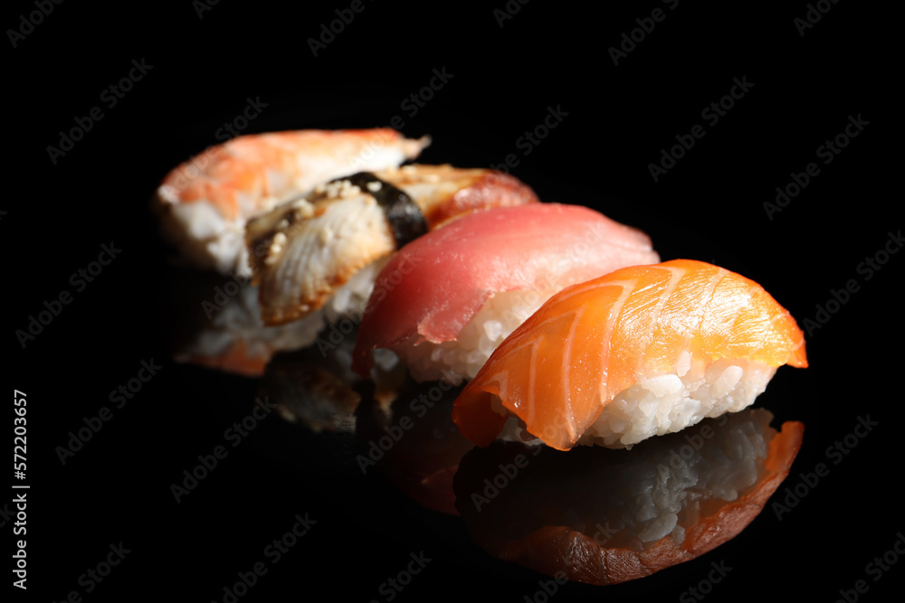 Delicious nigiri sushi on black background. Traditional Japanese cuisine Delicious nigiri sushi on black background. Traditional Japanese cuisine