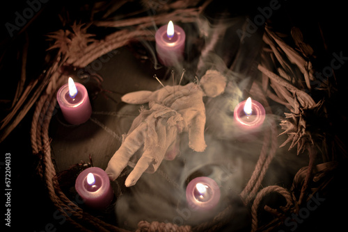 Konstfotografi Occultist dripping hot wax on voodoo doll, magic rituals, black spell, horror