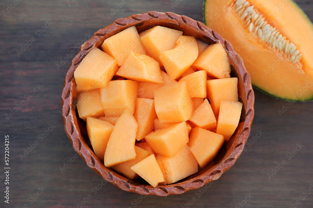 Cut delicious ripe melon on wooden table, flat lay Cut delicious ripe melon on wooden table, flat lay