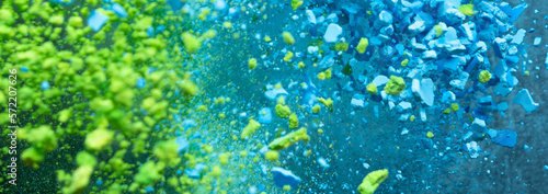 Fototapeta Naklejka Na Ścianę i Meble -  A burst of colorful blue-green particles. Abstract splash banner background with selective focus.