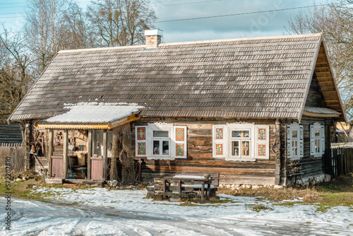 Beautiful old traditional wooden house in the village of Margionys, Dzūkija or Dainava region, Lithuania, in winter or spring photo