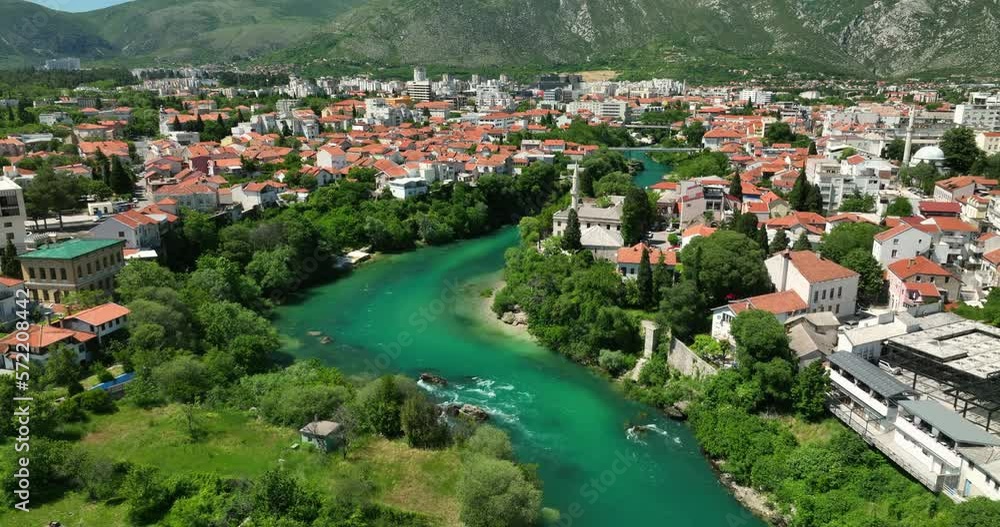 Aerial views of Mostar city in Bosnia with a flowing blue river. Aerial views of Mostar city in Bosnia with a flowing blue river.