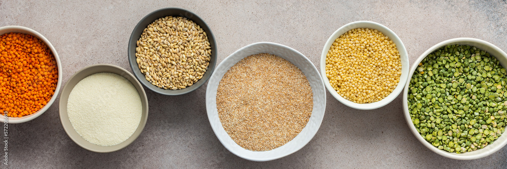 Various grain cereals in bowls banner, top view Various grain cereals in bowls banner, top view