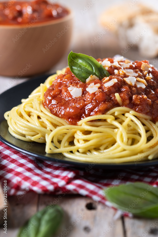 Spaghetti with bolognese sauce on wooden table