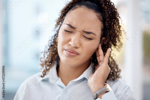 Injury, earache and medical with woman in pain for tinnitus, sound and noise problem. Healthcare, pressure and hearing loss with girl suffering with nerve infection for loud, deaf risk and illness photo