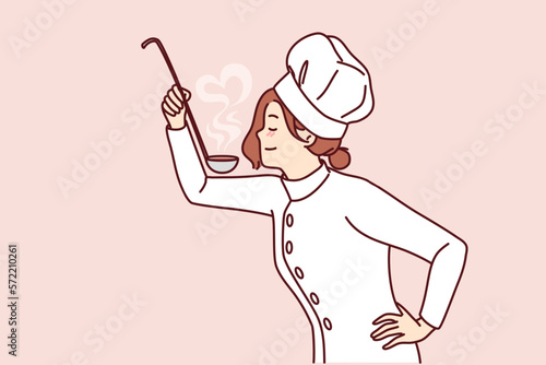 Woman cook with ladle in hand tries soup or sauce from menu preparing dish for restaurant guests. Girl in uniform and cook chef hat cooks food enjoying favorite job in cafe or diner 