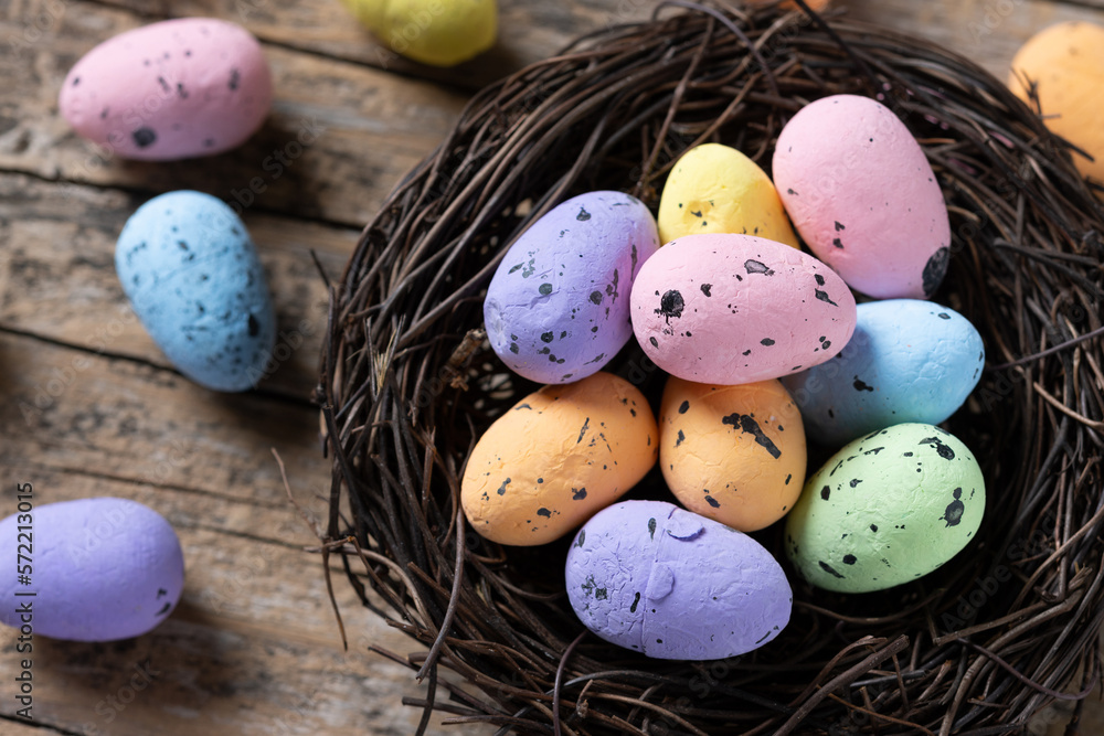 Colorful Easter eggs inside a nest on wooden table