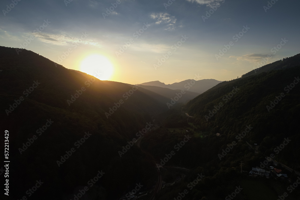 Aerial view during a sunset over Prahova Valley and DN1 national road from Romania at the bottom of Bucegi Mountains. Aerial view during a sunset over Prahova Valley and DN1 national road from Romania at the bottom of Bucegi Mountains.