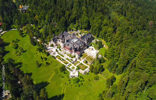 Obraz na płótnie Aerial view of Peles Castle with Bucegi Mountains in background during a beautiful sunny day. Landmarks of Romania. w salonie