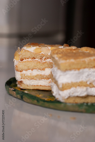 View on two pieces of cake with cream lemon and almonds