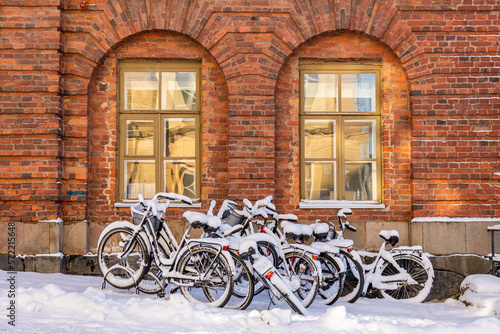 Bicycles left in a parking spot with a thick layer of fresh snow. © Thomas