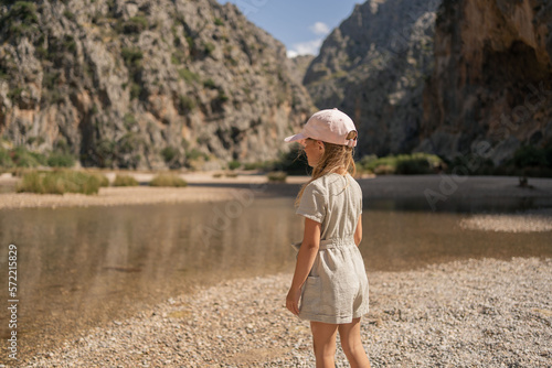 Child little girl exploring the famous canyon in Mallorca , Torrent de Pareis. © Julija