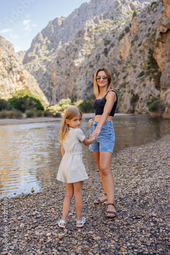Woman and child girl enjoy exciting canyon, Torent de Parais gorge. Spain , Mallorca.