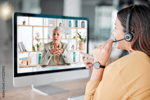 Customer service, computer video chat and woman in call center pointing at shocked client. Telemarketing, virtual conference and female sales agent, consultant or worker in online meeting in office.
