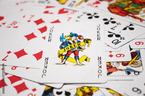 a jumble of cards with a joker on top