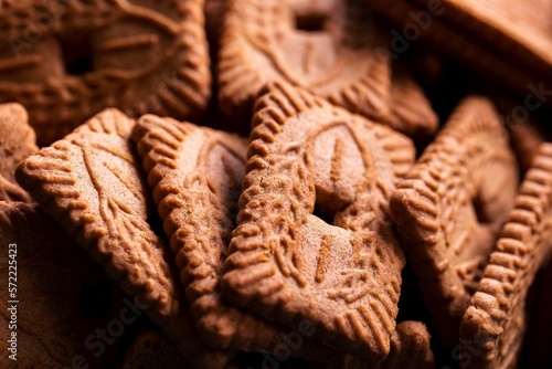 A close up of a pile of brown cookies called speculaas or speculoos in Belgium or the Netherlands. The spiced biscuit is very delicious and popular during the winter period to be eaten at any time.