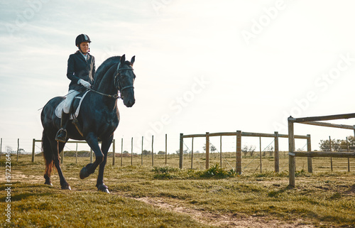 Woman, equestrian, horse ride and mockup in nature in countryside and grass field. Animal training, young jockey and farm of a rider and athlete with mock up outdoor doing saddle sports with horses © Kirsten D/peopleimages.com