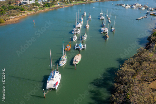 Aerial view of yachts anchored in lines on a calm coastal bay photo