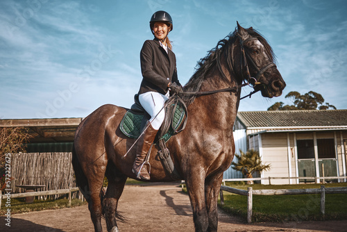 Equestrian, hobby and portrait of woman on horse for a ride, recreation and lessons on a farm. Sports, exercise and girl doing horseback riding for a competition, learning or training in countryside © Kirsten D/peopleimages.com