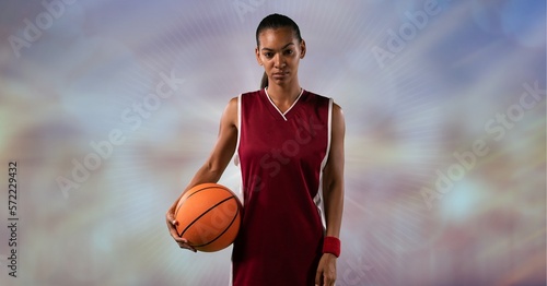 Composition of female basketball player holding basketball with copy space photo