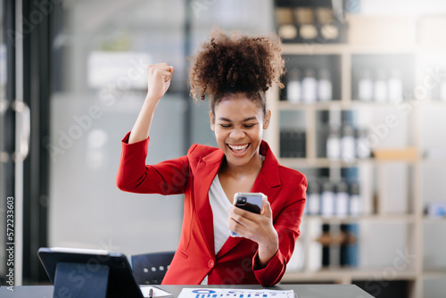 Asian business woman are delighted and happy with the work they do on their tablet, laptop and taking notes at the office..