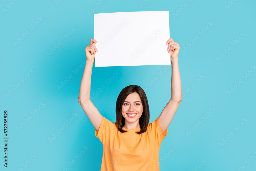 Photo of adorable lady wear orange clothes hold paper sheet calls ban involvement animal circus isolated on blue color background Photo of adorable lady wear orange clothes hold paper sheet calls ban involvement animal circus isolated on blue color background