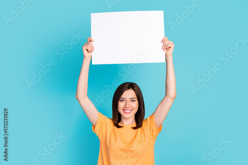 Photo of adorable lady wear orange clothes hold paper sheet calls ban involvement animal circus isolated on blue color background