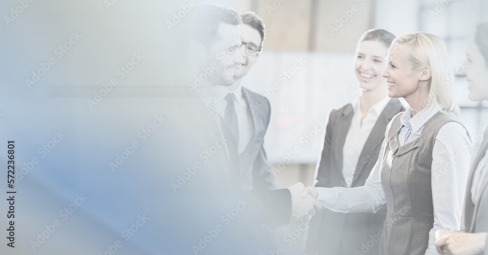 Obraz premium Composition of happy diverse business team shaking hands with motion blur
