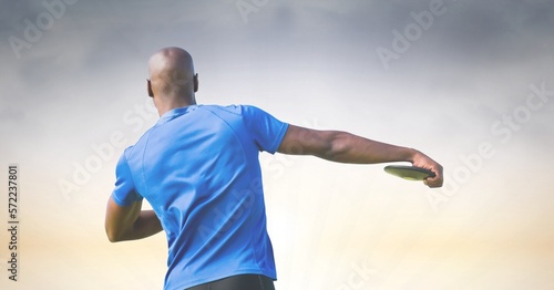 Composition of rear view of african american male athlete throwing discus