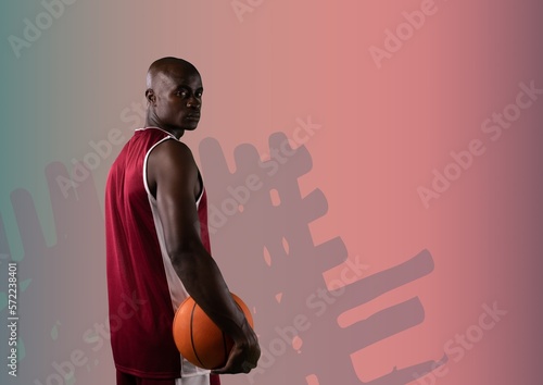 Composition of african american male basketball player with ball with copy space on pink background
