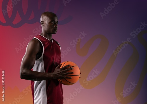 Composition of african american male basketball player with ball and copy space on purple background