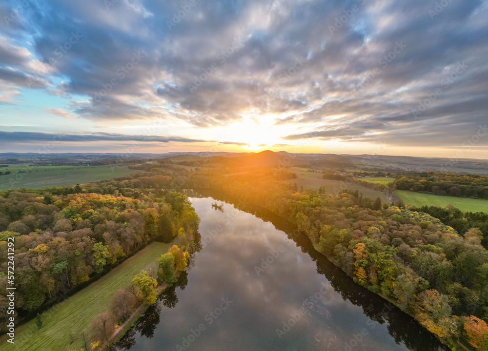 Water reflection at sunset time. Evening autumn landscape. Czech Republic. Aerial view from drone.