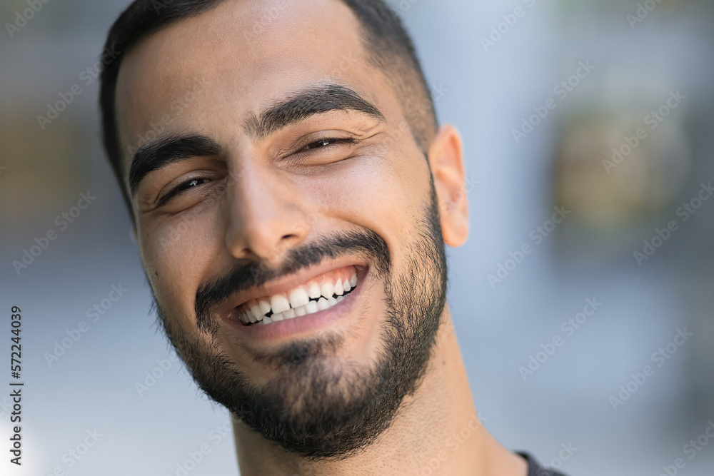Portrait of happy iranian confident man laughing and looking at camera Portrait of happy iranian confident man laughing and looking at camera