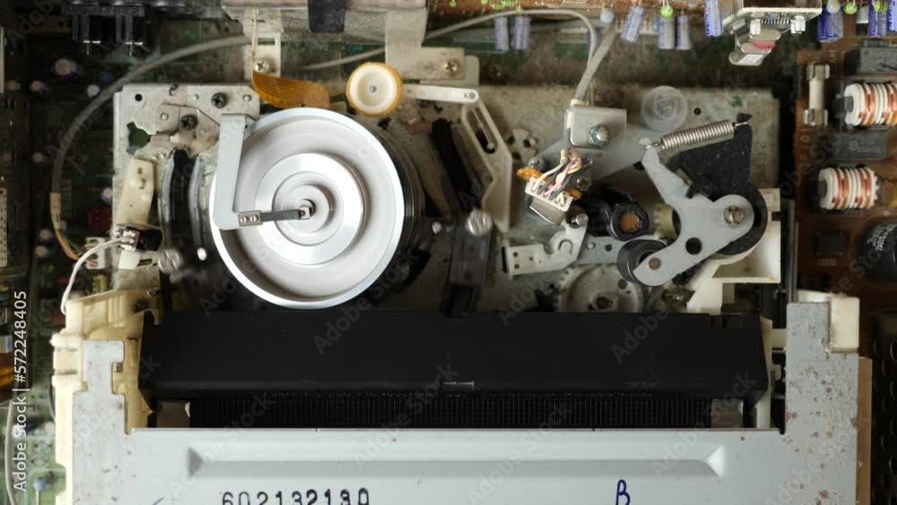 Loading a VHS tape and the operation of the tape extension mechanism of the video player. View from above. Video imaging technologies. Loading a VHS tape and the operation of the tape extension mechanism of the video player. View from above. Video imaging technologies.